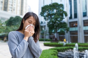 allergy woman blowing nose